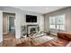 Cozy living room featuring a brick fireplace, hardwood floors, and lots of natural light at 1740 Bouldercrest Se Rd, Atlanta, GA 30316