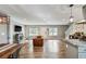 Spacious open-concept living room with hardwood floors, fireplace, and modern lighting fixtures at 1740 Bouldercrest Se Rd, Atlanta, GA 30316