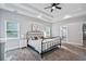 Spacious bedroom with tray ceiling, neutral walls, carpet flooring, and ensuite bathroom entrance at 1740 Bouldercrest Se Rd, Atlanta, GA 30316