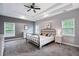 Spacious bedroom with tray ceiling, neutral walls, carpet flooring, and abundant natural light from multiple windows at 1740 Bouldercrest Se Rd, Atlanta, GA 30316