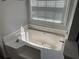 Large bathtub in a bathroom with natural light from a nearby window at 2436 Moultrie Ct, Dacula, GA 30019