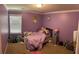 Cozy bedroom with a window letting in natural light at 2436 Moultrie Ct, Dacula, GA 30019