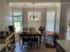 Breakfast nook with an abundance of natural light and stylish chandelier at 2436 Moultrie Ct, Dacula, GA 30019