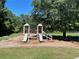 Community playground with slides, climbing structures and bench seating at 2436 Moultrie Ct, Dacula, GA 30019