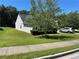 Expansive and well-manicured side yard featuring lush green grass, and a neatly trimmed hedge at 2436 Moultrie Ct, Dacula, GA 30019
