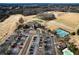 Aerial view showcasing the golf course, putting green, tennis courts, clubhouse, and parking area at 352 Southgate Dr, Locust Grove, GA 30248