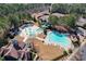 Aerial view showcasing the community pools, splash pad, tennis courts, and playground surrounded by mature trees at 352 Southgate Dr, Locust Grove, GA 30248
