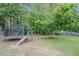 Large backyard featuring a trampoline and mature trees at 352 Southgate Dr, Locust Grove, GA 30248