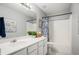 Bathroom with grey walls, a white shower and tub with a floral shower curtain, and a white vanity at 352 Southgate Dr, Locust Grove, GA 30248