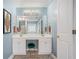 Bathroom vanity featuring dual sinks, framed mirrors, and light fixture at 352 Southgate Dr, Locust Grove, GA 30248