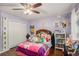 Bedroom featuring a ceiling fan, hard wood floors, and a large closet at 352 Southgate Dr, Locust Grove, GA 30248