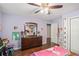 Bedroom features a dark wood dresser, wood floors, and natural light at 352 Southgate Dr, Locust Grove, GA 30248
