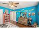 Bedroom featuring wood floors, bright blue walls, and themed decor at 352 Southgate Dr, Locust Grove, GA 30248