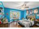 Bright bedroom features blue walls, a ceiling fan, and a bay window at 352 Southgate Dr, Locust Grove, GA 30248