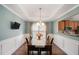 Elegant dining room with wainscoting, tray ceiling, and hardwood floors at 352 Southgate Dr, Locust Grove, GA 30248