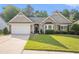 Charming home featuring a well-manicured lawn, attached garage, and inviting curb appeal at 352 Southgate Dr, Locust Grove, GA 30248
