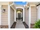 Inviting front entryway with detailed trim, updated door, and attractive landscaping at 352 Southgate Dr, Locust Grove, GA 30248
