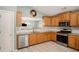 Well-lit kitchen with stainless steel appliances, light wood cabinets, and bright tile floors at 352 Southgate Dr, Locust Grove, GA 30248