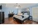 Bright primary bedroom featuring hardwood floors, a tray ceiling, and decorative accents at 352 Southgate Dr, Locust Grove, GA 30248