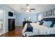 This main bedroom features light blue walls, wood floors, and a ceiling fan at 352 Southgate Dr, Locust Grove, GA 30248