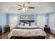 Spacious main bedroom features a trey ceiling, fan, and neutral-colored walls and bedding at 352 Southgate Dr, Locust Grove, GA 30248
