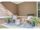 Outdoor seating on a covered patio with brick accents at 352 Southgate Dr, Locust Grove, GA 30248