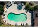 Overhead shot of a community pool area featuring lounge chairs and tables with umbrellas for residents' enjoyment at 352 Southgate Dr, Locust Grove, GA 30248