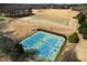 Aerial view showcasing the well-maintained tennis courts within the community, surrounded by mature trees at 352 Southgate Dr, Locust Grove, GA 30248