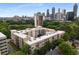 Aerial view of the apartment building with green trees and the downtown city skyline at 384 Ralph Mcgill Ne Blvd # 318, Atlanta, GA 30312