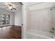Modern bathroom with a soaking tub, tiled shower, and an adjoining bedroom with hardwood floors at 384 Ralph Mcgill Ne Blvd # 318, Atlanta, GA 30312