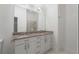 Bathroom with double sink, granite countertop, white cabinets, and shower with glass door at 384 Ralph Mcgill Ne Blvd # 318, Atlanta, GA 30312