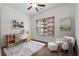 Bright bedroom featuring a desk, chair, ottoman, ceiling fan and large window with city views at 384 Ralph Mcgill Ne Blvd # 318, Atlanta, GA 30312