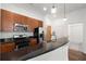 Modern kitchen featuring a black countertop island, stainless steel appliances, and wood cabinets at 384 Ralph Mcgill Ne Blvd # 318, Atlanta, GA 30312