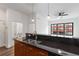 Modern kitchen featuring a black countertop island and view into the living and bath rooms at 384 Ralph Mcgill Ne Blvd # 318, Atlanta, GA 30312