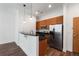 Modern kitchen with stainless steel appliances, granite countertops, wood cabinets, and stylish pendant lighting at 384 Ralph Mcgill Ne Blvd # 318, Atlanta, GA 30312