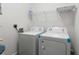 Convenient laundry area includes washer, dryer, and shelving for storage solutions at 384 Ralph Mcgill Ne Blvd # 318, Atlanta, GA 30312