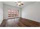 Bright bedroom with hardwood floors and glass doors leading to an outdoor balcony overlooking the city at 384 Ralph Mcgill Ne Blvd # 318, Atlanta, GA 30312