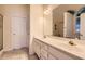 Bathroom with double sinks, white cabinets, and a large mirror at 595 Mcgarity Dr, Mcdonough, GA 30252