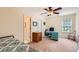 Bedroom featuring neutral carpet, ceiling fan and lots of natural light at 595 Mcgarity Dr, Mcdonough, GA 30252
