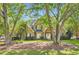 Beautiful brick home with lush green lawn framed by mature trees, offering a serene setting at 595 Mcgarity Dr, Mcdonough, GA 30252