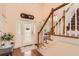 Bright foyer with hardwood floors, staircase, and decorative door, offering a welcoming entrance at 595 Mcgarity Dr, Mcdonough, GA 30252