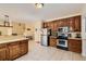 Open concept kitchen with breakfast bar, wooden cabinets, and stainless steel appliances at 595 Mcgarity Dr, Mcdonough, GA 30252