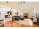Open-concept living room with hardwood floors, fireplace, and vaulted ceiling at 595 Mcgarity Dr, Mcdonough, GA 30252