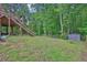 Lush backyard features a staircase, storage shed, and tree line at 2582 Oak Bluff Dr, Dacula, GA 30019