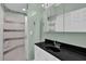 Bathroom with an enclosed shower and vanity with black countertop at 2582 Oak Bluff Dr, Dacula, GA 30019