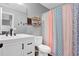 Bright bathroom featuring a white vanity, modern faucet, and decorative shower curtain at 2582 Oak Bluff Dr, Dacula, GA 30019