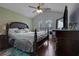 Comfortable bedroom with ample natural light, with wood floors, fan, and large dresser at 2582 Oak Bluff Dr, Dacula, GA 30019