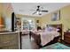 Cozy bedroom with a ceiling fan, window, and decorative artwork at 2582 Oak Bluff Dr, Dacula, GA 30019