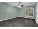 Bedroom with a ceiling fan, and a window overlooking a treed backyard at 2582 Oak Bluff Dr, Dacula, GA 30019