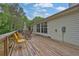 Wooden deck featuring a dining table, chairs, and views of the backyard at 2582 Oak Bluff Dr, Dacula, GA 30019